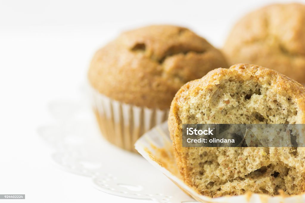 Homemade Whole Wheat Bran Muffins on White Cake Stand. Visible Dough Texture. Breakfast Morning Healthy Pastry Baking Concept. Minimalist Style Copy Space Homemade Whole Wheat Bran Muffins on White Cake Stand. Visible Dough Texture. Breakfast Morning Healthy Pastry Baking Concept. Minimalist Style American Culture Stock Photo