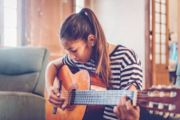istock Cuban teenager playing guitar 924403158