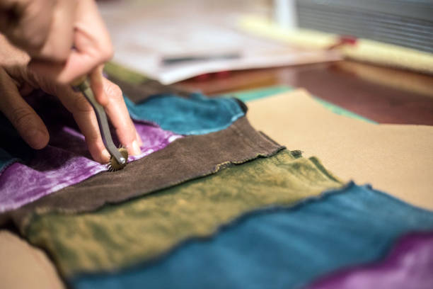 istock Mature Woman Marking a Sewing Pattern from another Hooded Shirt 924403348