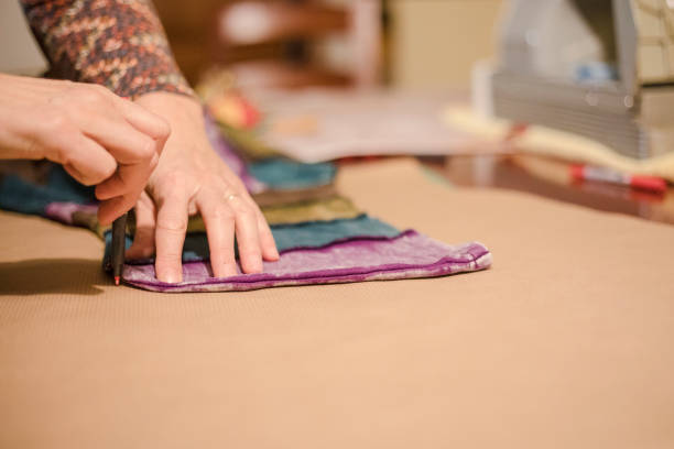 istock Mature Woman Marking a Sewing Pattern from another Hooded Shirt 924403392