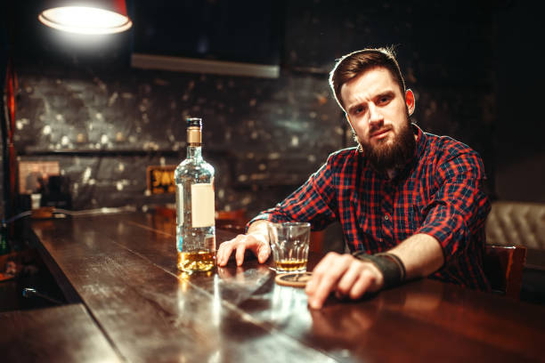 istock Alcoholic sitting at bar and drinks strong alcohol 924405852