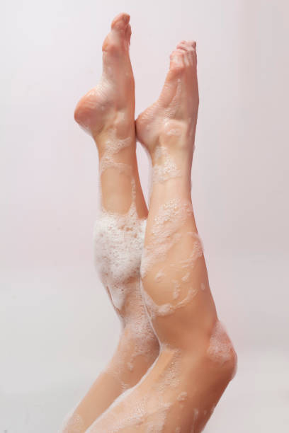 istock women legs with foam bath on white background 924407118