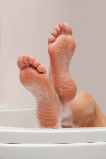 istock women feet with foam bath on white background 924407134
