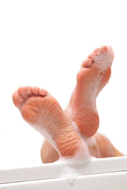 istock women feet with foam bath on white background 924407154