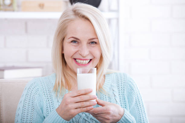 istock Happy middle aged woman drinking milk 924411430
