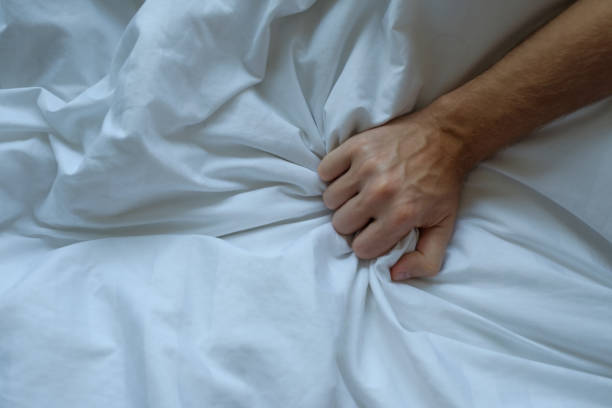 istock Caucasian man hand grasping on bed 924414784