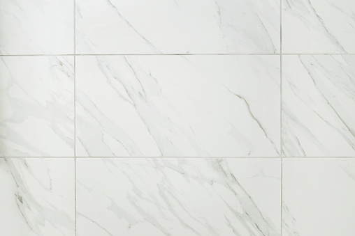 closeup of large marble tile bathroom wall