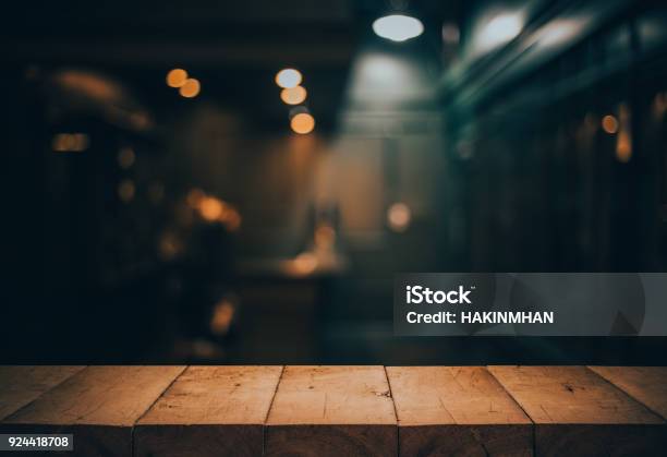 Wood Table Top On Blurred Of Counter Cafe Shop With Light Bulbbackground For Montage Product Display Or Design Key Visual Stock Photo - Download Image Now