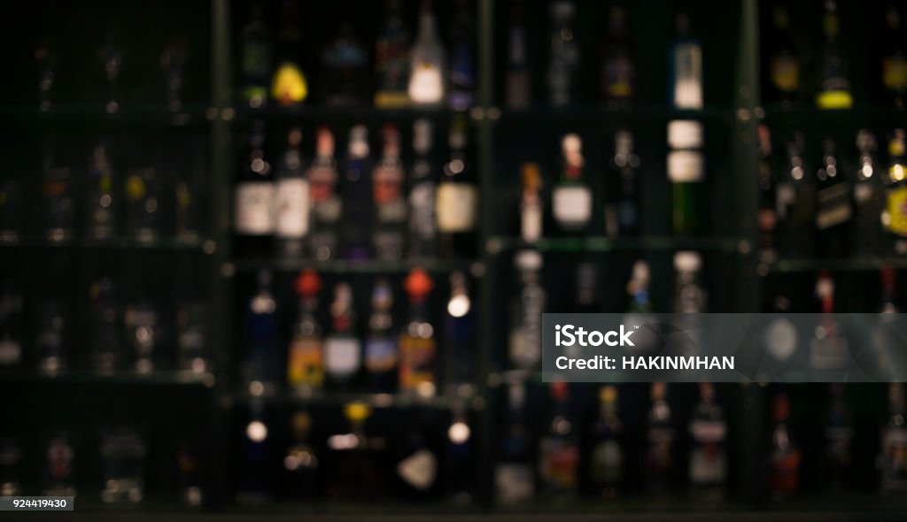 Blur of bottles counter bar Background blur of bottles counter bar Background in dark Bar - Drink Establishment Stock Photo