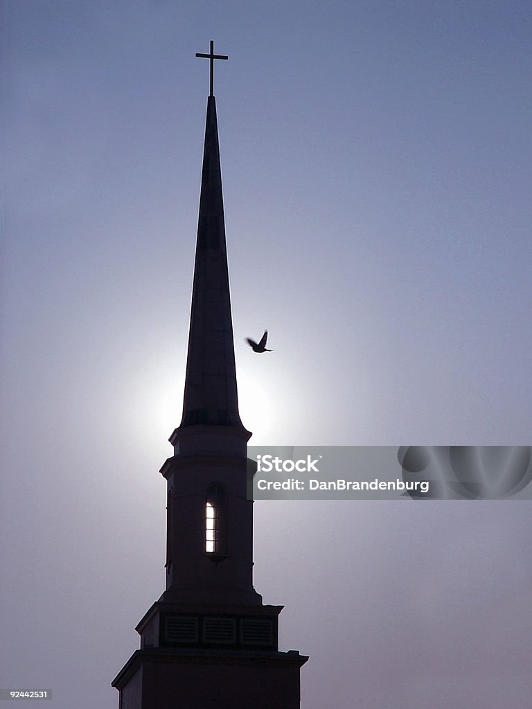 Illuminated Church Steeple Illuminated church steeple with passing dove. Architecture Stock Photo