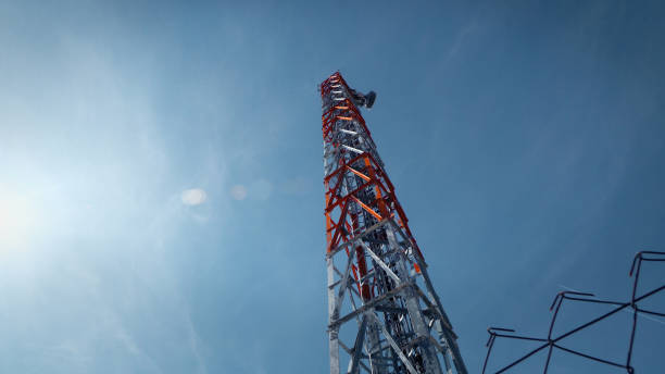 istock Communication Tower against blue sky and sun flares 924425488