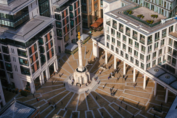 London stock exchange and Paternoster Square near St Pauls Cathedral London UK LONDON, UK - OCTOBER 30, 2012: Pedestrians crossing the Paternoster Square next to St Paul's Cathedral and London stock exchange (LSE) in the City of London paternoster square stock pictures, royalty-free photos & images