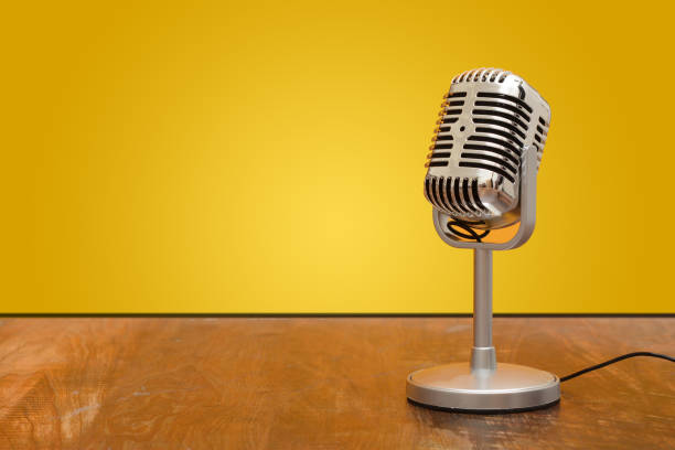istock Retro style microphone recorder in studio with yellow background 924426116