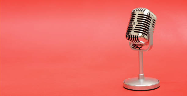 istock Retro vintage style metal microphone on red background banner 924426146