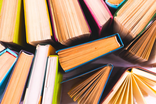istock Open book, hardback books on bright colorful background. 924426322