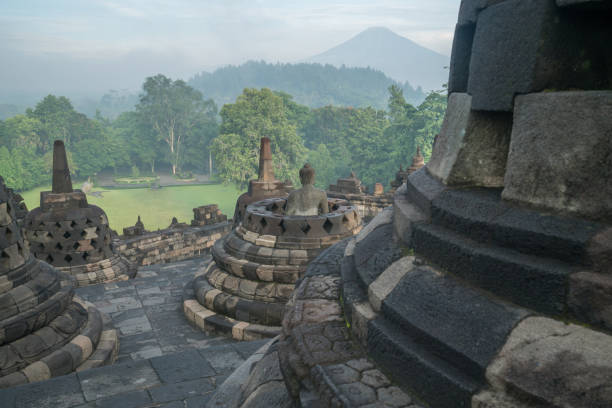 istock Borobudur temple at sunrise, Buddha statue in stupa, Central Java, Indonesia 924429308
