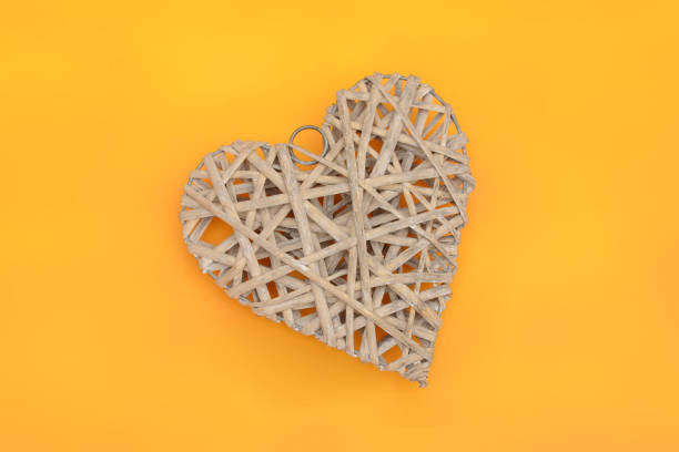 istock Wooded Heart Design on yellow banner background 924429480