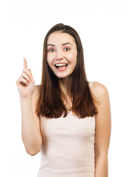 istock Cheerful beautiful young woman pointing up 924429796