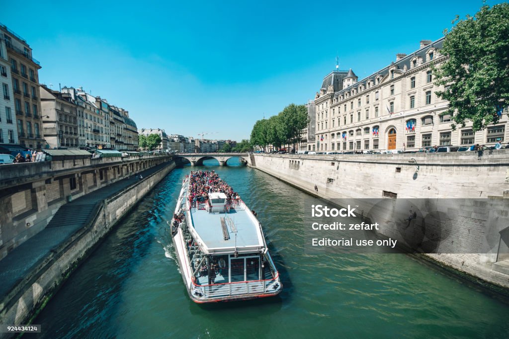 Tourist Boat At Narrow Chanel Near Notre Dame With Bridge Pont Saintmichel  Over River Seine In Paris France Stock Photo - Download Image Now - iStock