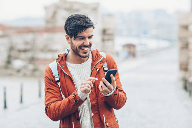 istock Tourist texting outdoors on a rainy day 924437492