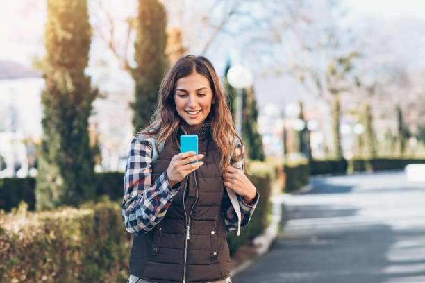 istock Beautiful tourist texting outdoors in an old town 924437500