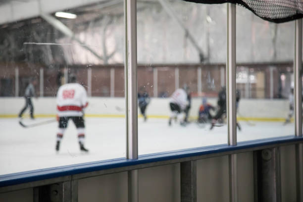 istock Boards at a hockey rink with a game going on behind 924440556