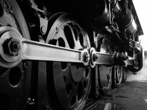 large metal wheels of an old train at a railway transport exhibition