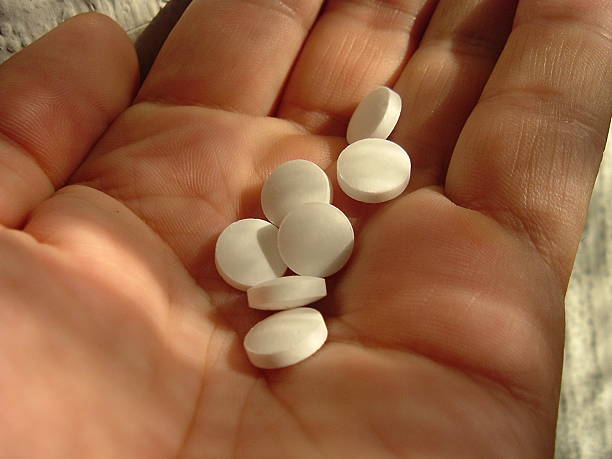 Pills in hand close up of a hand with pills over the counter meds stock pictures, royalty-free photos & images