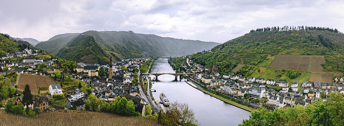 Beautiful high angle city view of historic old town Cochem with the typical half-timbered colorful houses, hotels and restaurants, Reichsburg Imperial castle landmark on a mountain, Mittelmosel, Moselle river, Rhineland-Palatinate in rainy spring time Rheinland-Pfalz Deutschland, Europe