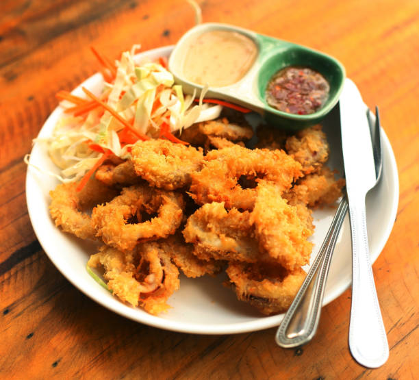 istock platter with deep fried squid rings,salad sweet and sore sauce served for lunch 924447562