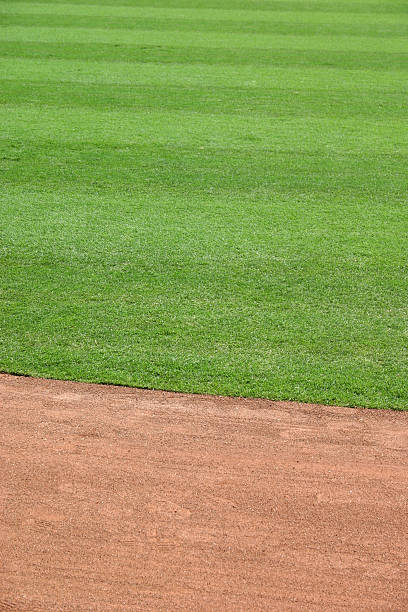 istock Red gravel track with green grass field 92444830