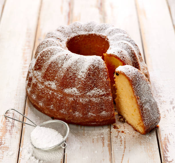 istock Easter yeast cake sprinkled with powdered sugar on a wooden white table. 924454132