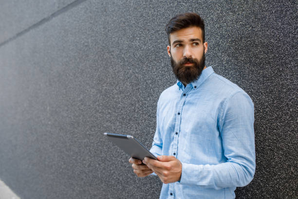 istock Young hipster businessman holding digital tablet 924454310