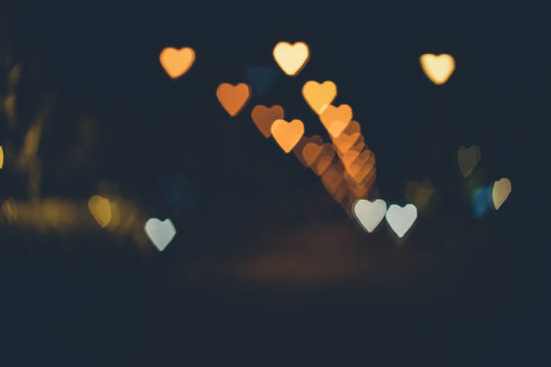 istock Heart shape bokeh from street light background, Love heart background 924454476