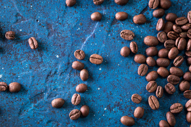 istock roasted coffee beans on blue table, can be used as a background 924454652
