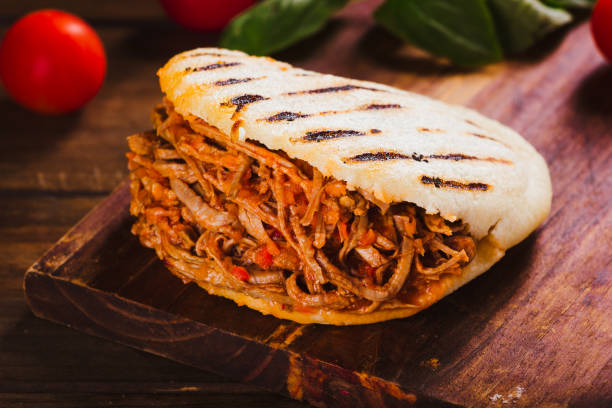 Freshly cooked Arepa with roasted meat stock photo