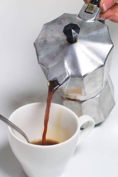 istock Barista pours coffee from a geyser coffee machine into a cup. 924455380