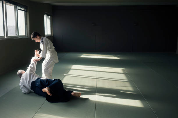 istock Teen boy with his sansei practicing in dojo 924455764