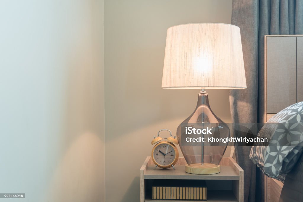 classic lamp on wooden table side classic lamp on wooden table side in modern bedroom, interior design concept Electric Lamp Stock Photo
