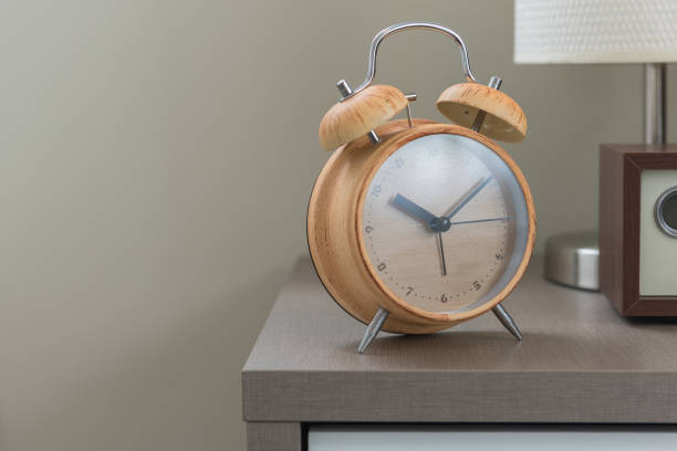 istock wooden modern alarm clock on bed 924456074