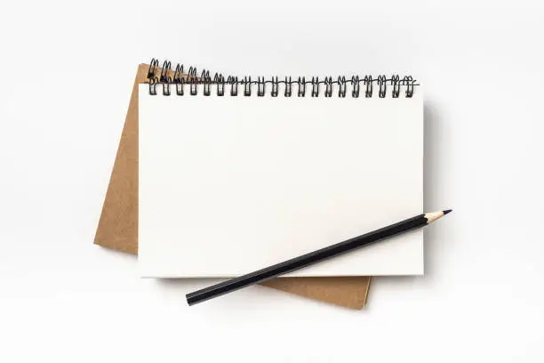 Business concept - Top view of two kraft spiral notebook and black pencil isolated on background for mockup