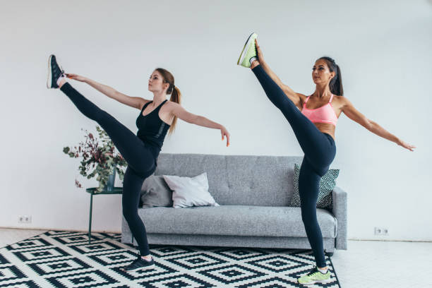 istock Fit woman stretching legs warming up workout at home 924461326
