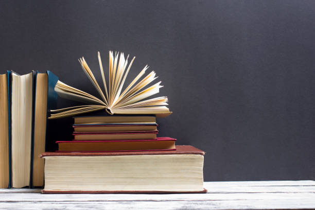 istock Open book, hardback books on wooden table. Back to school. Copy space 924464180