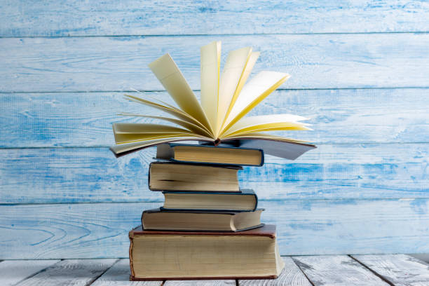 istock Open book, hardback books on wooden table. Back to school. Copy space 924464460