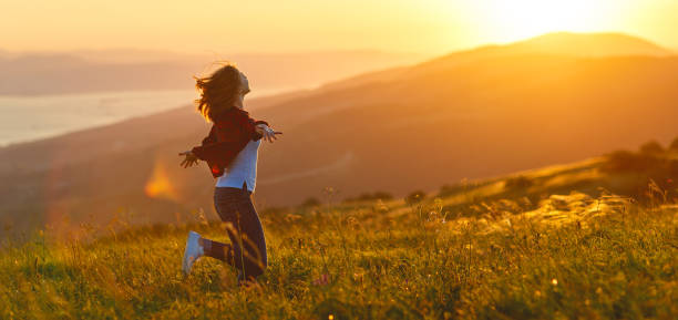 istock Happy woman   on sunset in nature iwith open hands 924467840