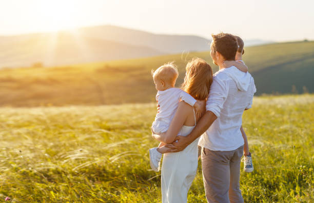 istock father's day. child daughter sits on her dad shoulders outdoors on a summer 924468106
