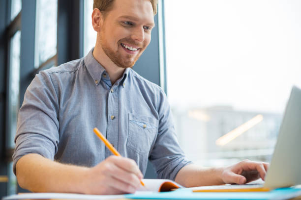 istock Cheerful positive man being involved in work 924469316