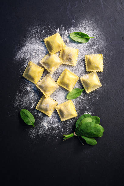 istock Ravioli with spinach and ricotta on dark background 924476858