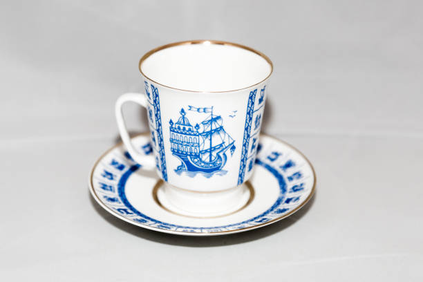 A stack of vintage antique teacups stacked up.