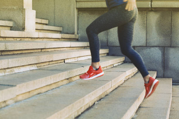 istock Sportswoman running up a staircase 924479766